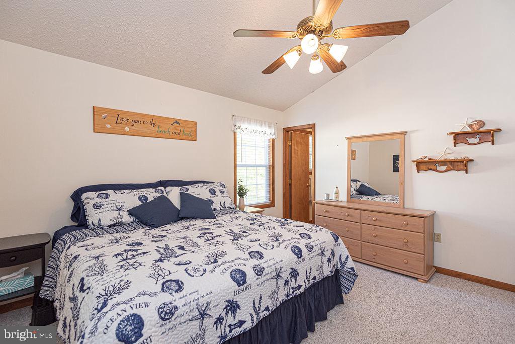 54 Abbyshire Road Ocean Pines, MD 21811 - Photo 13 of 43 a bedroom with a large bed and a chandelier