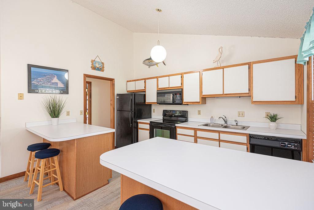 54 Abbyshire Road Ocean Pines, MD 21811 - Photo 7 of 43 a kitchen with stainless steel appliances kitchen island granite countertop a table chairs sink and cabinets