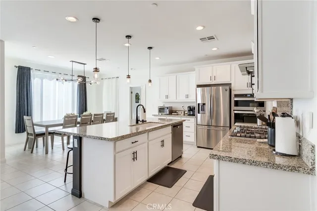 a kitchen with a sink a counter top space appliances and cabinets