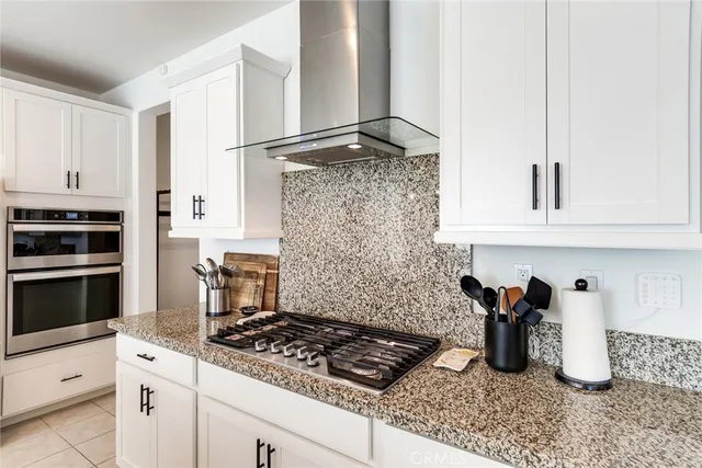 a kitchen with granite countertop a stove and a sink