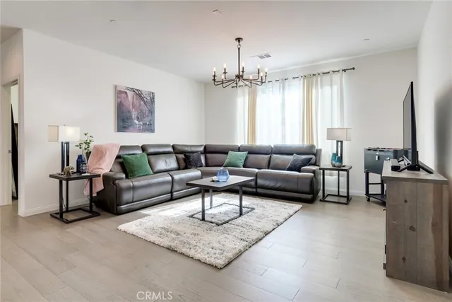 a living room with furniture and a chandelier