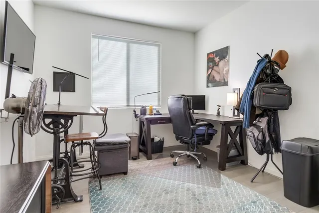 a view of a workspace with furniture and a window