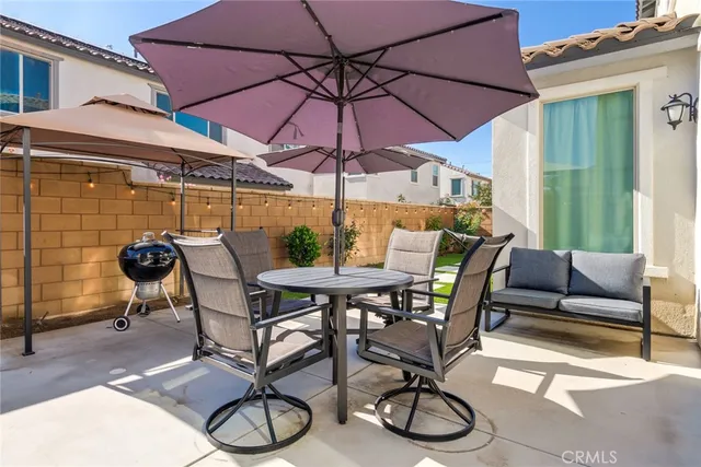 a patio with a patio table and chairs