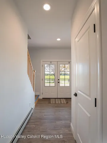a living room with furniture a flat screen tv and kitchen view
