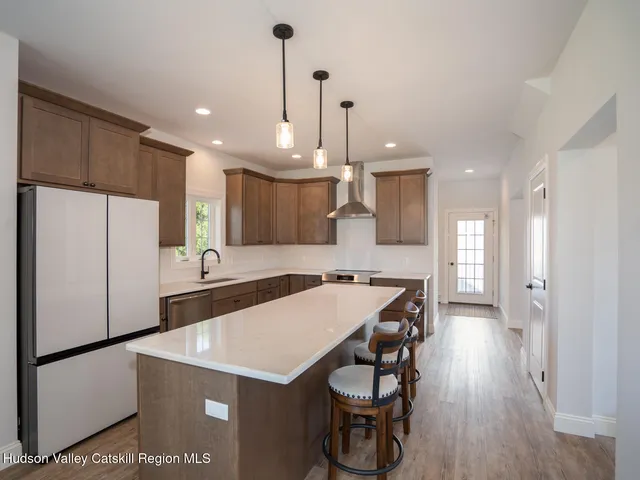 a kitchen with stainless steel appliances a sink and a refrigerator