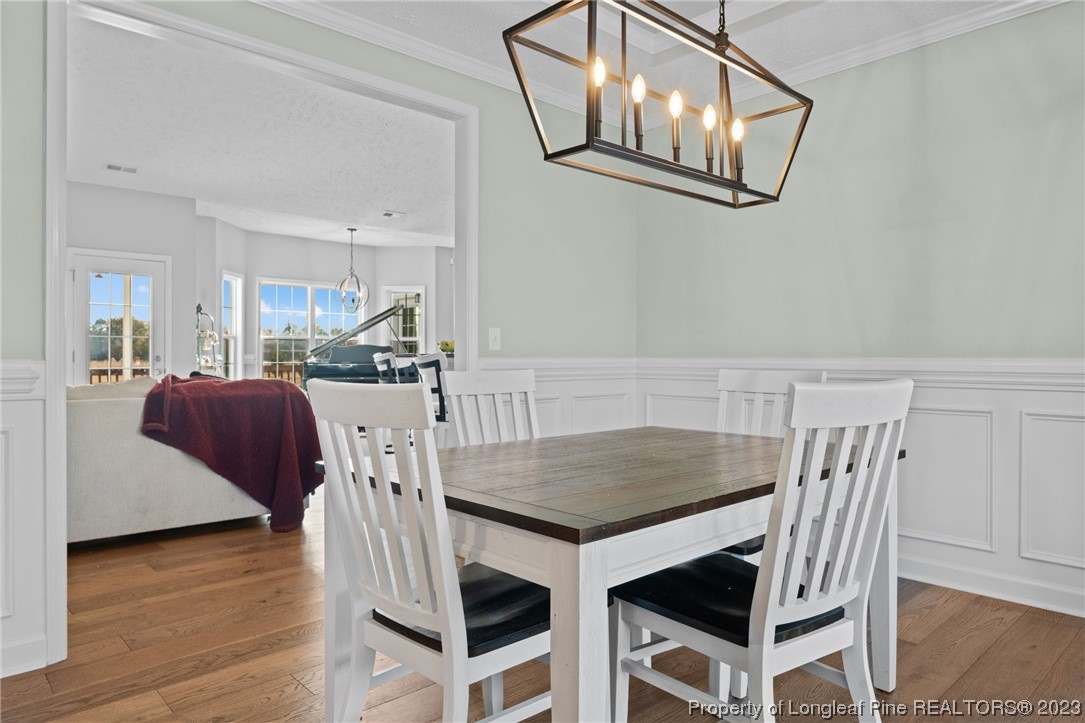 5654 Toby Pl Road Stedman, NC 28391 - Photo 14 of 42 a view of a dining room with furniture and wooden floor
