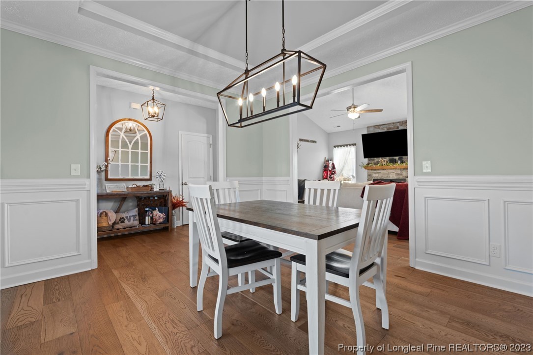 5654 Toby Pl Road Stedman, NC 28391 - Photo 15 of 42 a view of a dining room with furniture and a chandelier