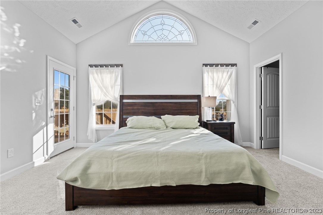5654 Toby Pl Road Stedman, NC 28391 - Photo 17 of 42 a large bed sitting in a bedroom next to a window