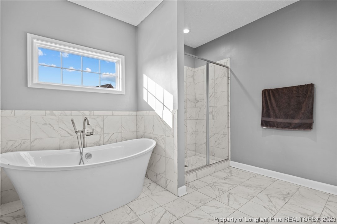 5654 Toby Pl Road Stedman, NC 28391 - Photo 20 of 42 a bathroom with a bathtub and shower