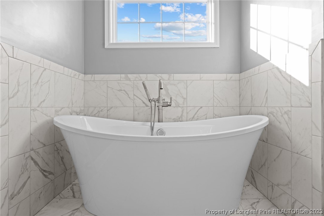5654 Toby Pl Road Stedman, NC 28391 - Photo 21 of 42 a white bath tub sitting in a bathroom