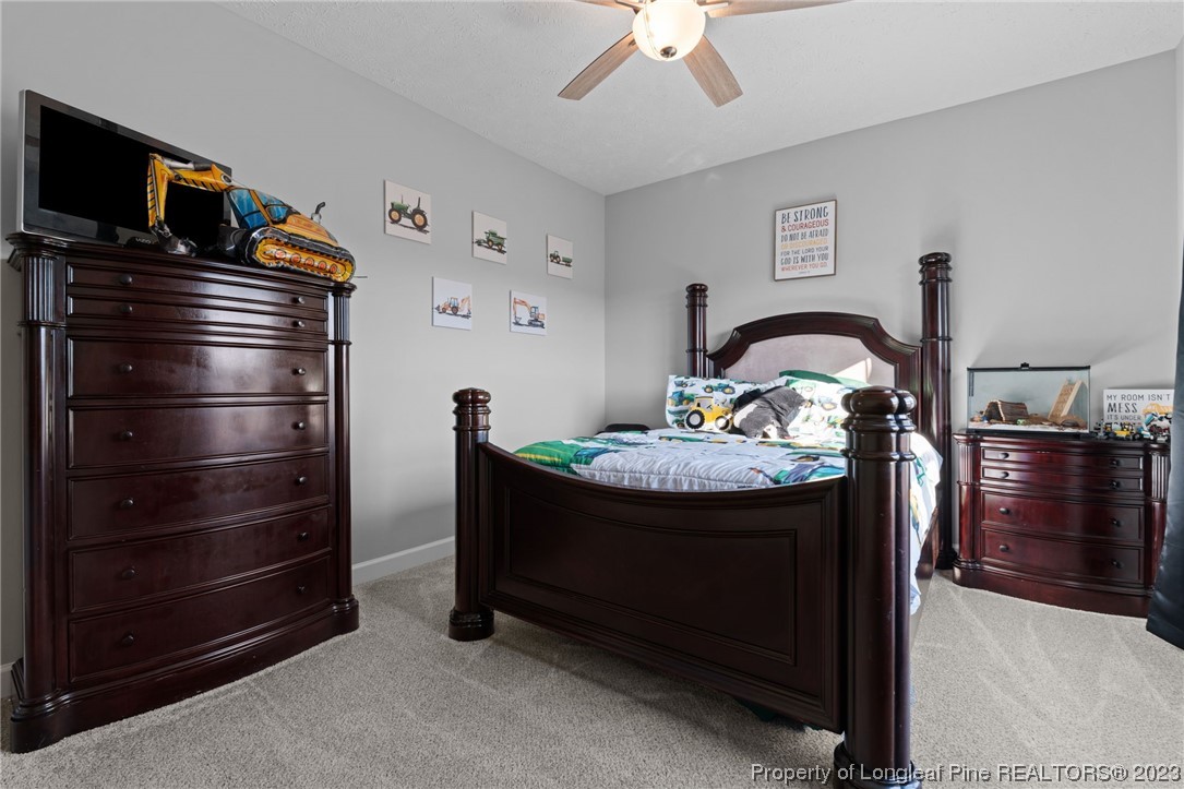 5654 Toby Pl Road Stedman, NC 28391 - Photo 23 of 42 a room with a refrigerator and a fireplace