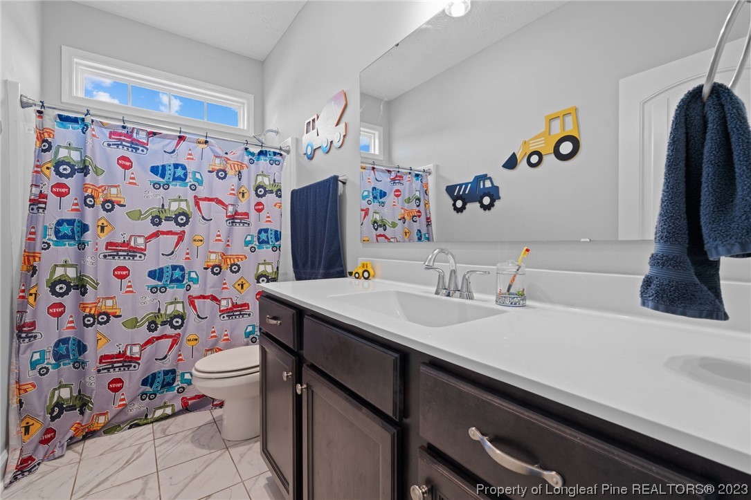 5654 Toby Pl Road Stedman, NC 28391 - Photo 24 of 42 a bathroom with a sink and a mirror