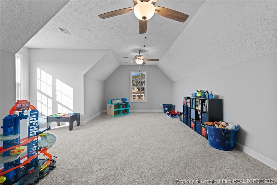 5654 Toby Pl Road Stedman, NC 28391 - Photo 27 of 42 a very nice looking room with a big bed and a chandelier