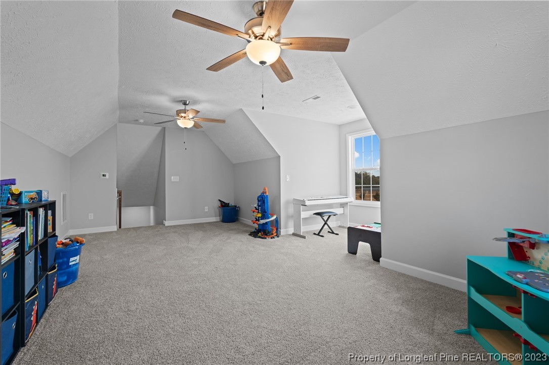 5654 Toby Pl Road Stedman, NC 28391 - Photo 29 of 42 a view of a room with toys and a ceiling fan