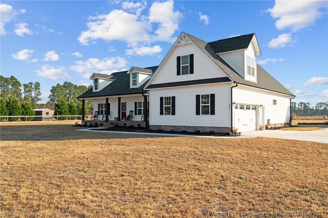 5654 Toby Pl Road Stedman, NC 28391 - Photo 34 of 42 a front view of a house with a yard and garage
