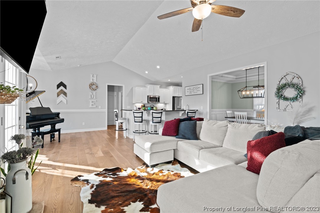 5654 Toby Pl Road Stedman, NC 28391 - Photo 5 of 42 a living room with furniture and a chandelier