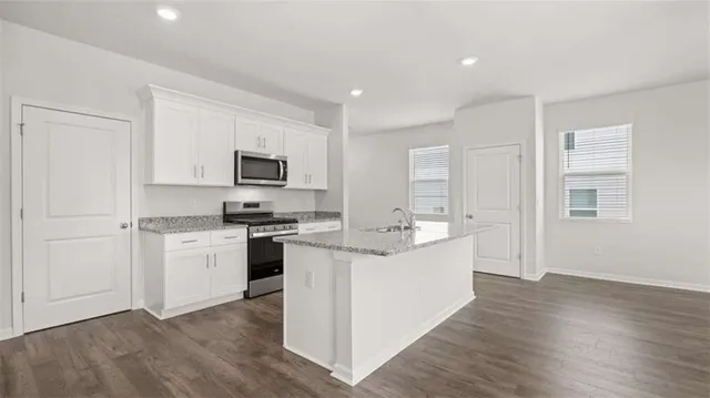 a kitchen with a sink stove and refrigerator