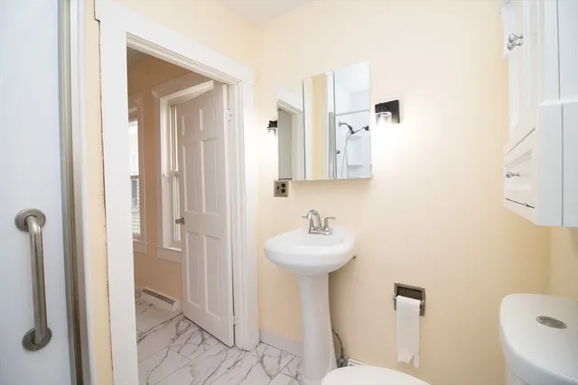 a bathroom with a sink toilet and shower