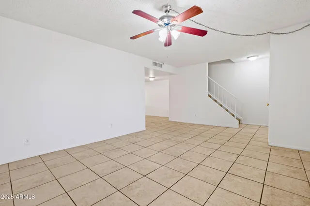 a view of a livingroom with a ceiling fan and window