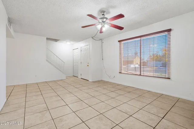 a view of a livingroom with a chandelier fan