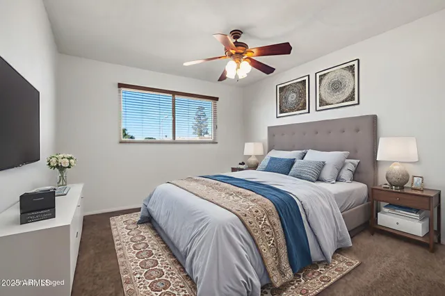 a bedroom with a bed and a flat screen tv