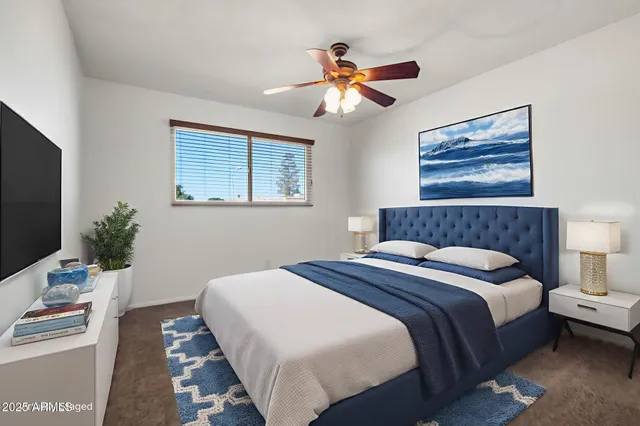 an empty room with a window and a fan