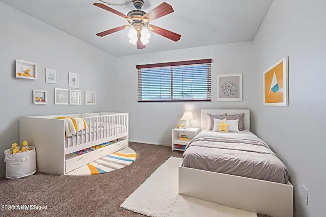 an empty room with a window and a fan