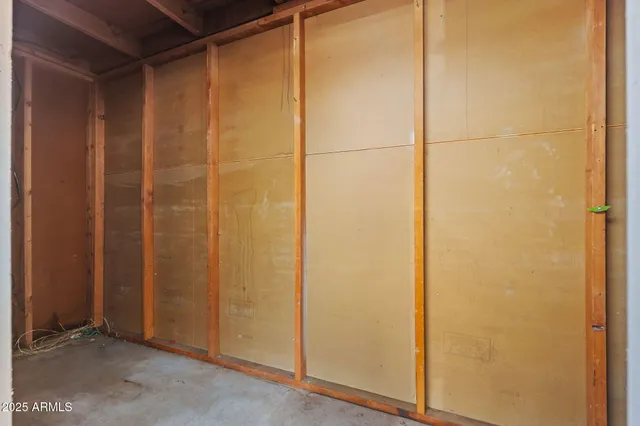 a view of a hallway with wooden floor and entryway