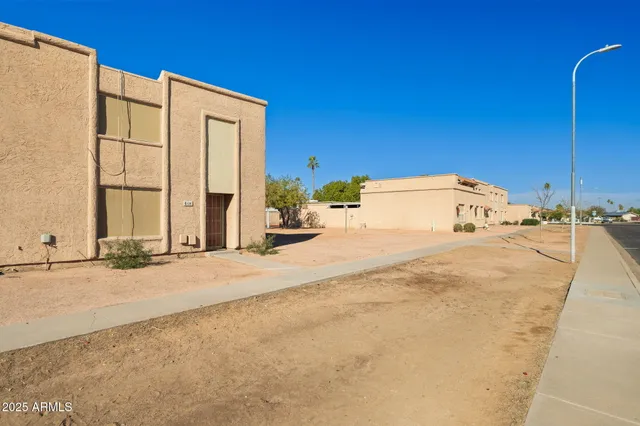 a view of a building with pathway and road
