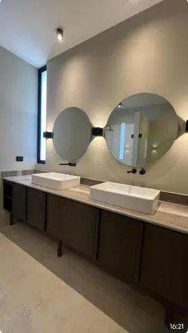 a bathroom with a double vanity sink and a mirror