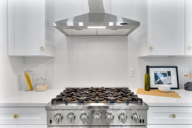 a kitchen with a stove and cabinets