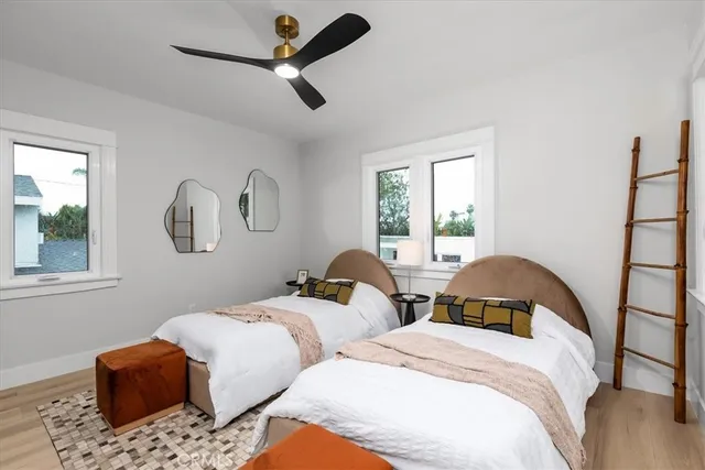 a bedroom with two beds and a window