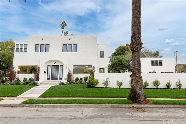 a front view of a house with a garden