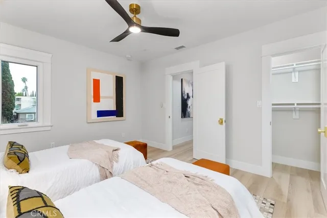 a bathroom with a toilet a sink a tub and mirror