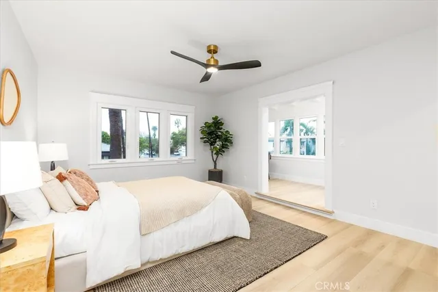 a bedroom with a bed mirror and couch
