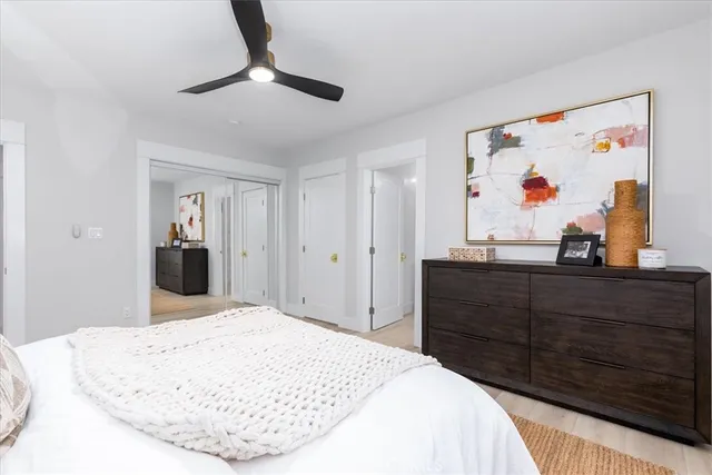 a bathroom with a granite countertop sink a toilet and a mirror