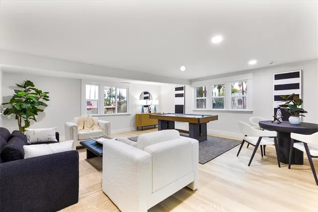 a living room with furniture a rug and a table