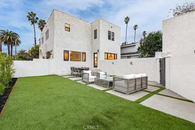 a view of backyard with outdoor seating and green space