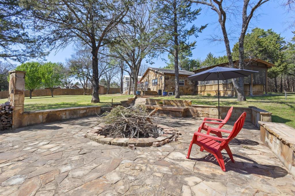 236 Homesite Road Pottsboro, TX 75076 - Photo 6 of 40 a view of a patio with a table and chairs under an umbrella