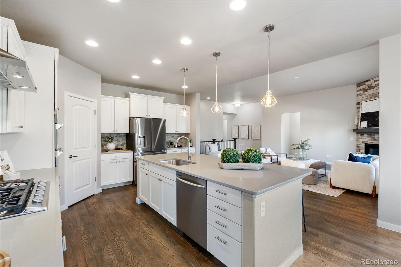 4508 Captain Jack Lane Colorado Springs, CO 80924 - Photo 16 of 50 a kitchen with a sink stove and wooden cabinets