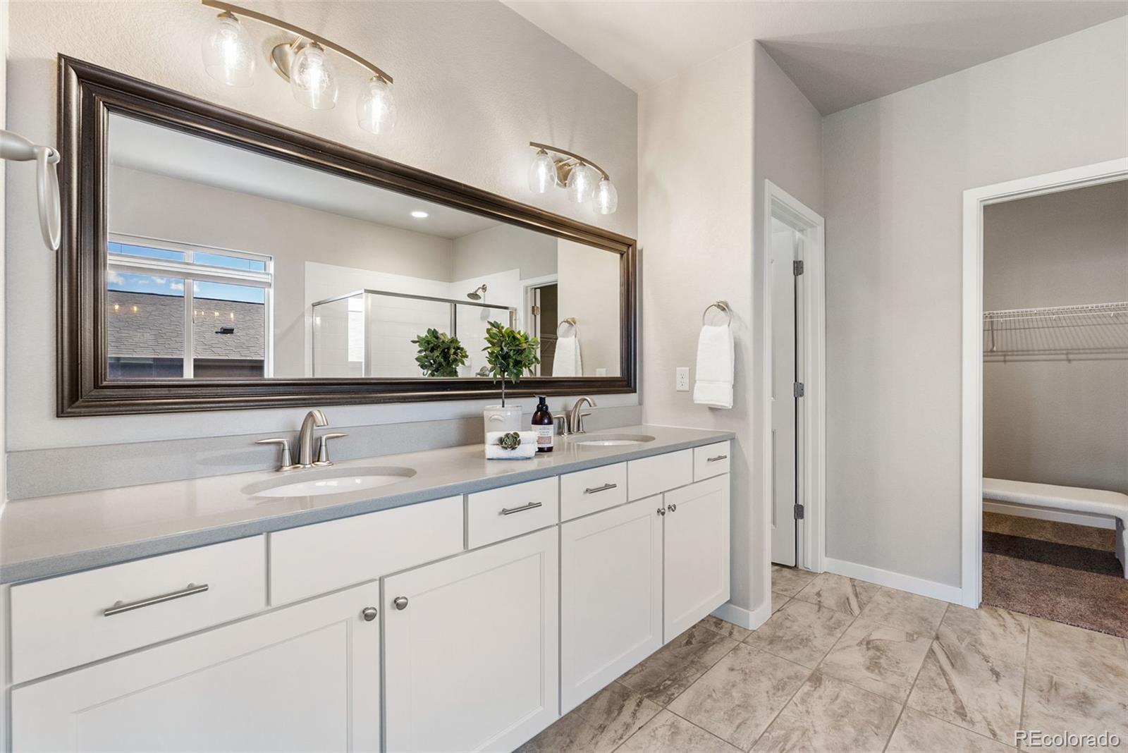 4508 Captain Jack Lane Colorado Springs, CO 80924 - Photo 21 of 50 a bathroom with a sink and a mirror