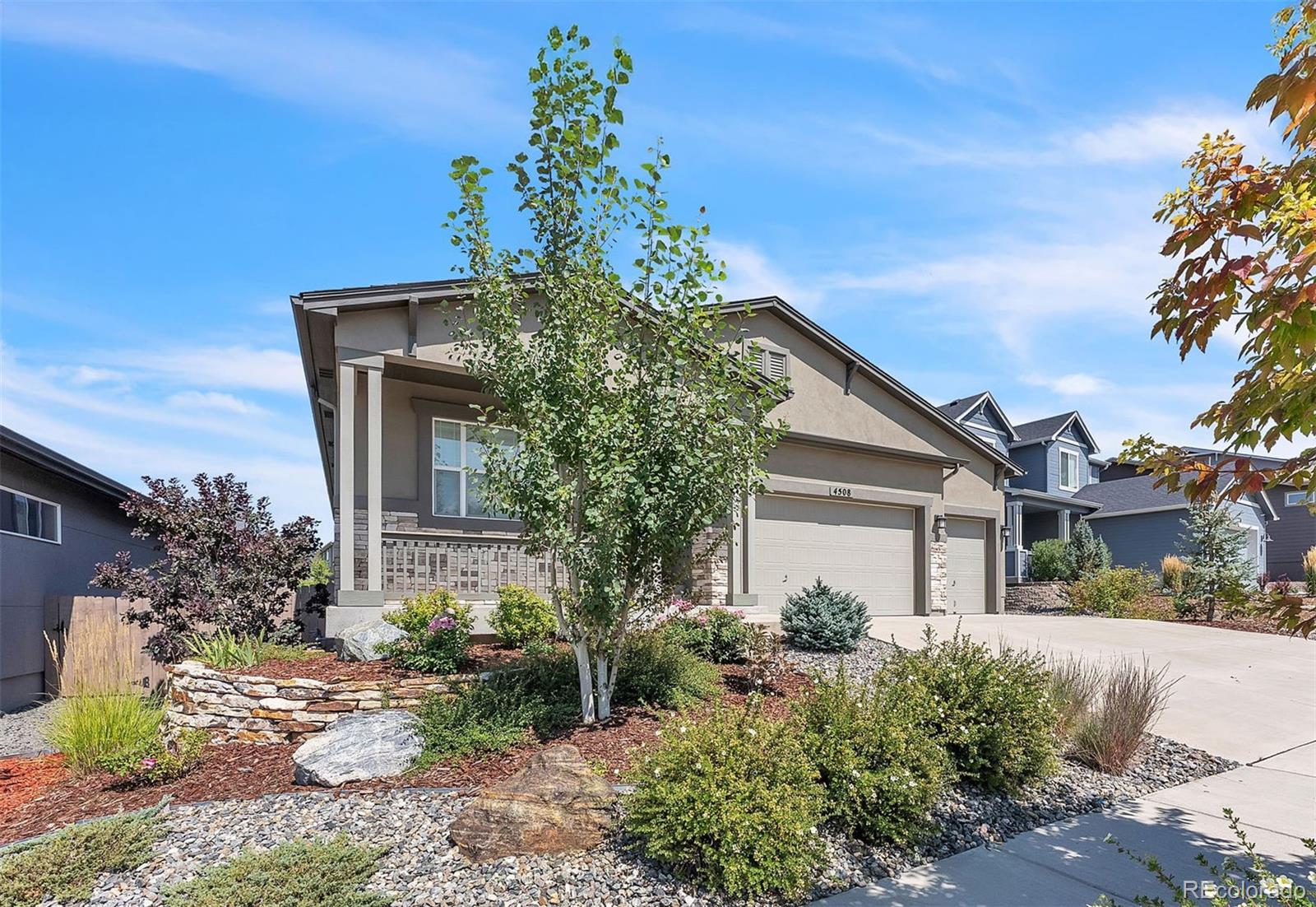 4508 Captain Jack Lane Colorado Springs, CO 80924 - Photo 3 of 50 a front view of a house with a yard
