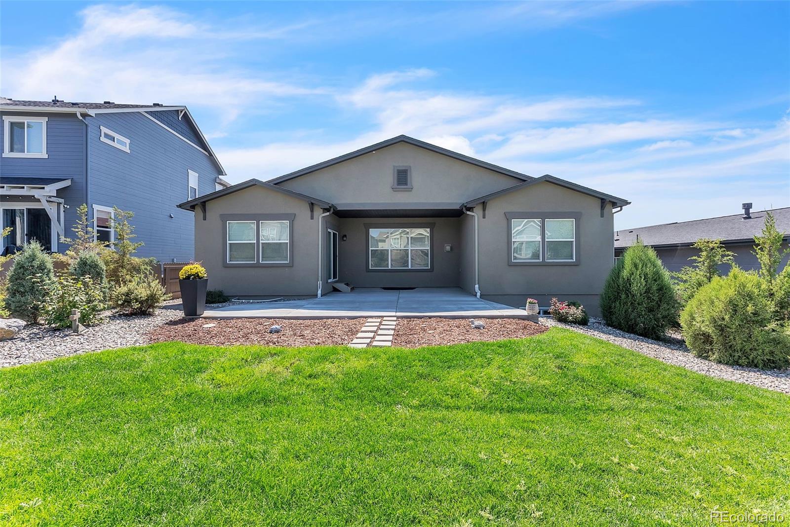 4508 Captain Jack Lane Colorado Springs, CO 80924 - Photo 38 of 50 a front view of a house with a yard and garage