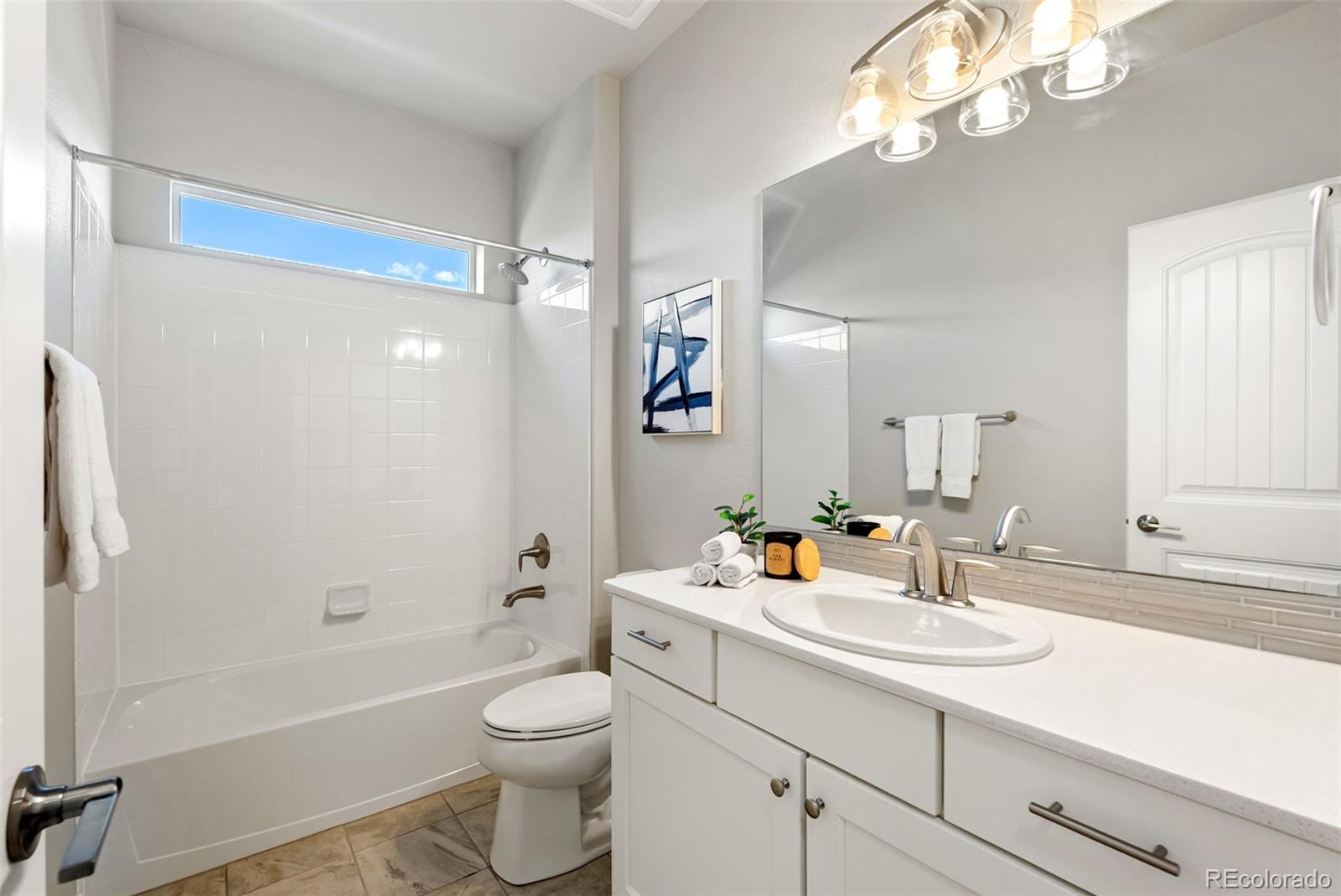 4508 Captain Jack Lane Colorado Springs, CO 80924 - Photo 7 of 50 a bathroom with a sink a toilet and shower