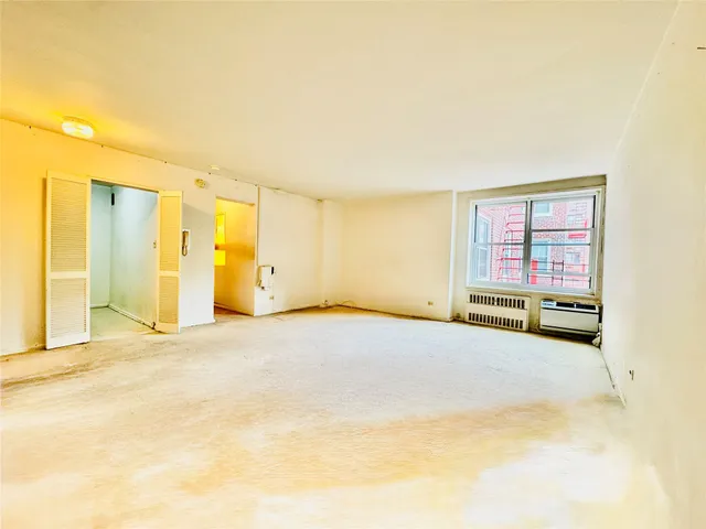 a view of an empty room with a window