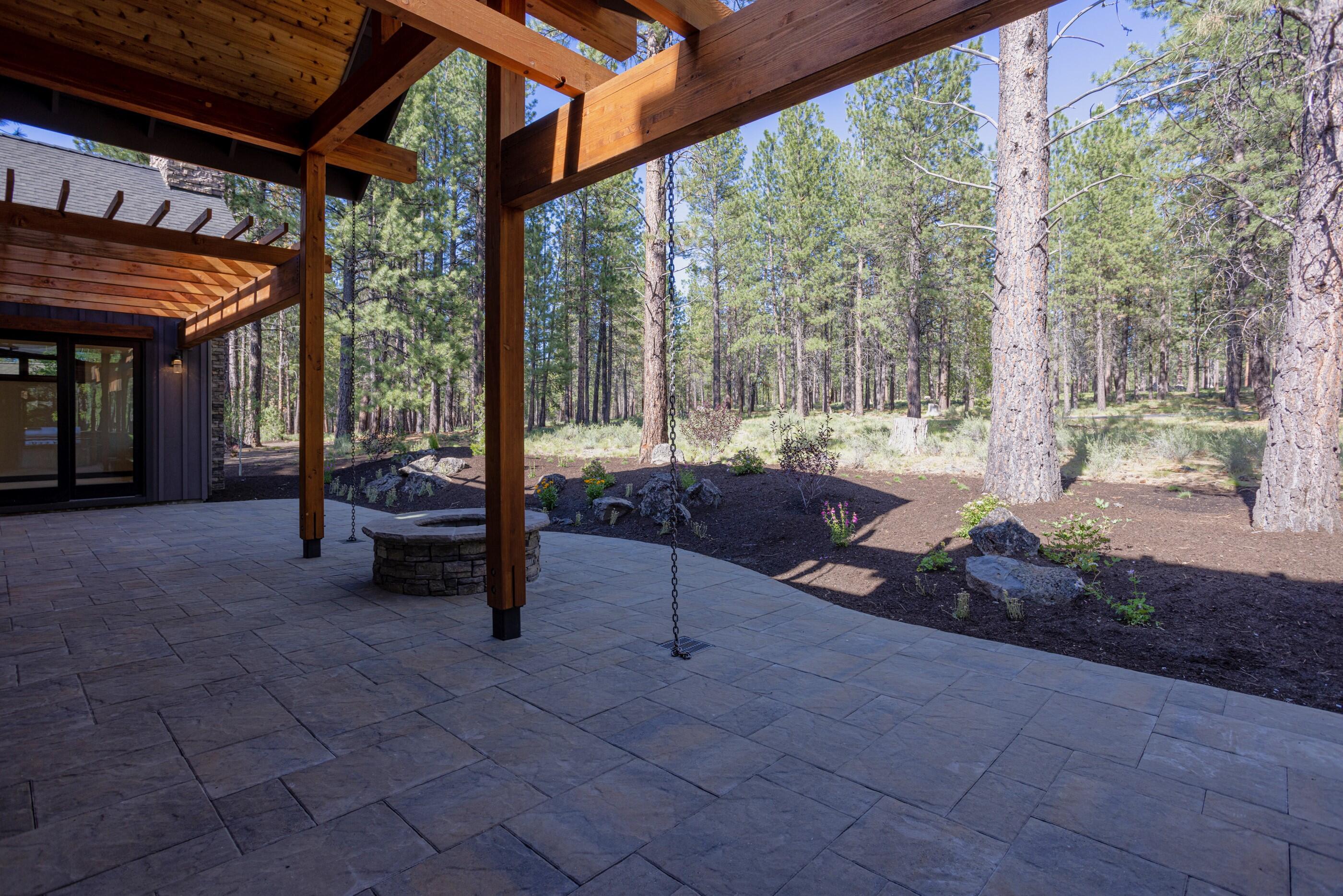 56593 Sunstone Loop, Unit 127 Bend, OR 97707 - Photo 29 of 46 Paver Patio with View to Woods