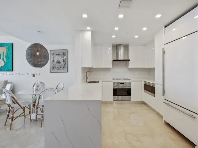 a kitchen with a table and chairs