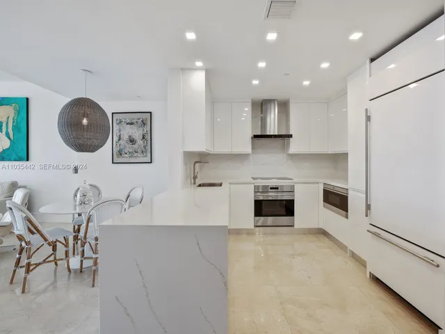 a kitchen with a table and chairs