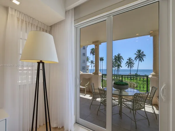 a view of a hallway with furniture and a potted plant
