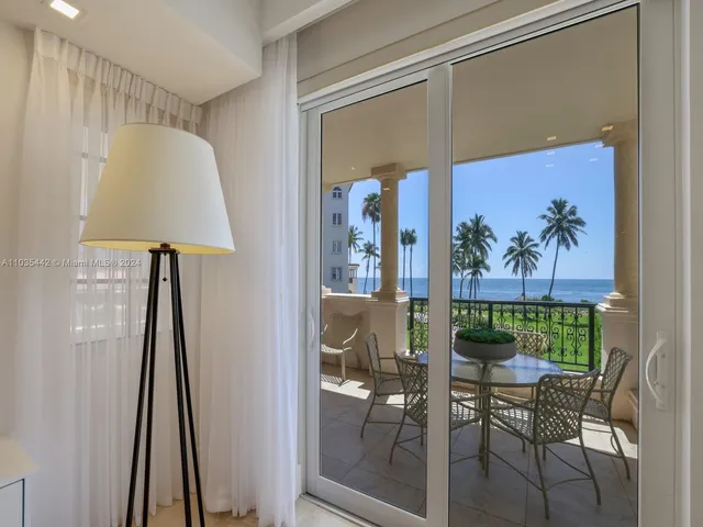 a view of a hallway with furniture and a potted plant